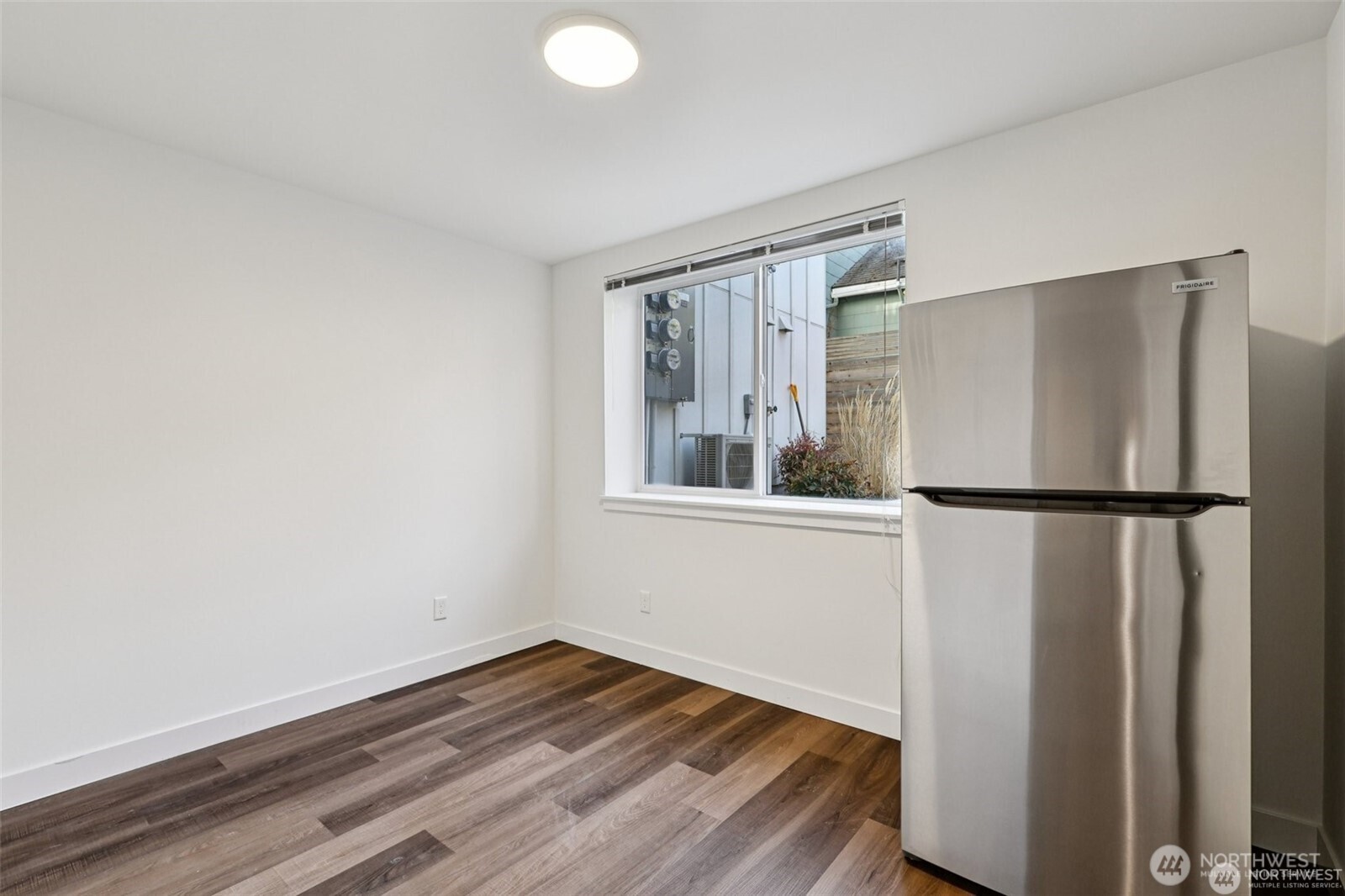 5259 Brooklyn Avenue Northeast Seattle, WA 98105 - Photo 9 of 40 a view of a kitchen with wooden floor and a refrigerator