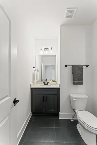 a bathroom with a toilet a sink and mirror