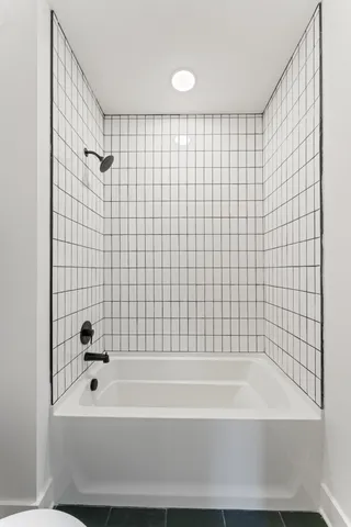 a bathroom with a bathtub and shower