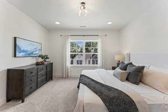 a bedroom with a large bed and a window