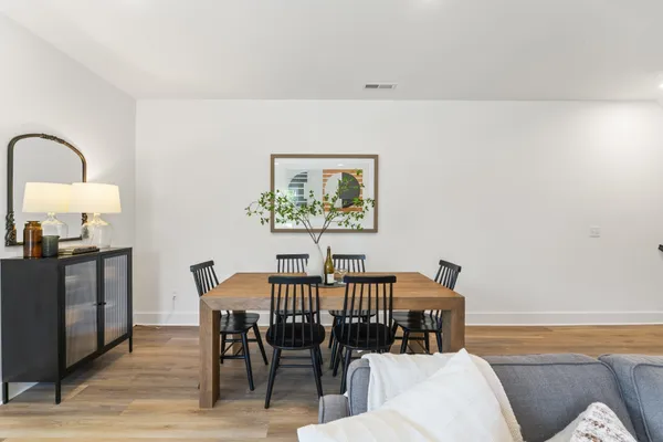 a view of a dining room with furniture and wooden floor