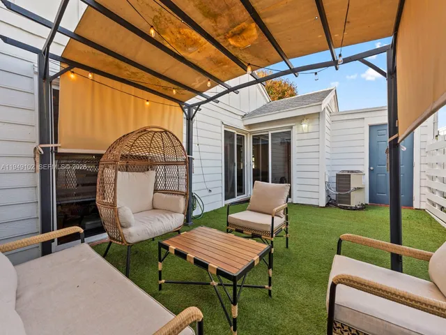 a view of a chairs in backyard of house