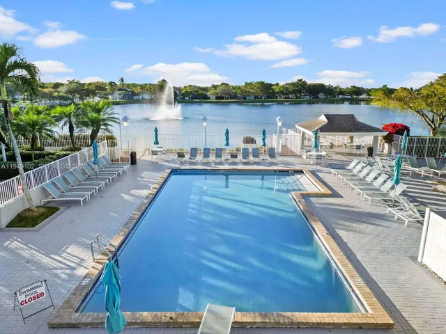 a view of a terrace with lawn chairs