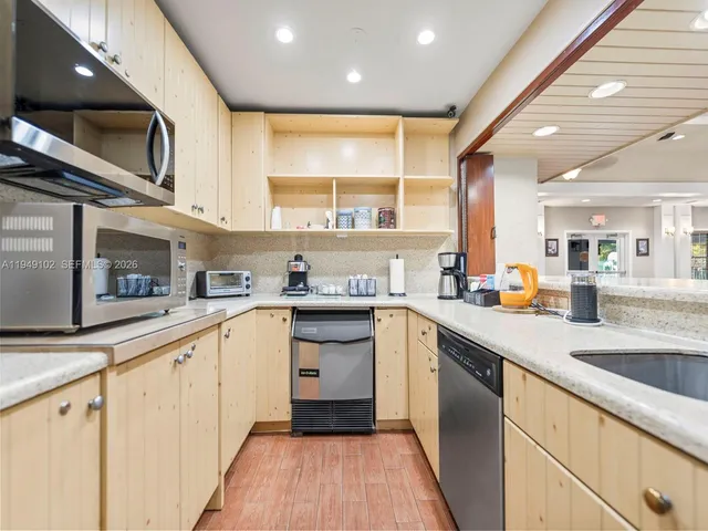a kitchen with stainless steel appliances granite countertop a sink and stove top oven