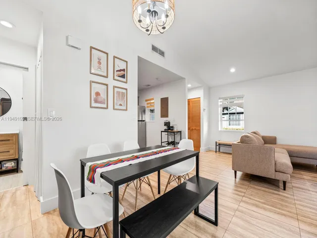a living room with furniture a couch and a chandelier