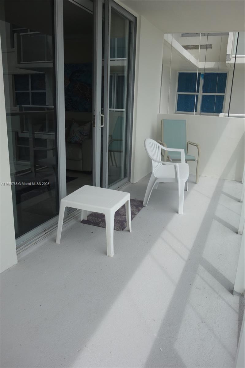 5701 Collins Avenue, Unit 1510 Miami Beach, FL 33140 - Photo 15 of 67 a white bench sitting in front of a house