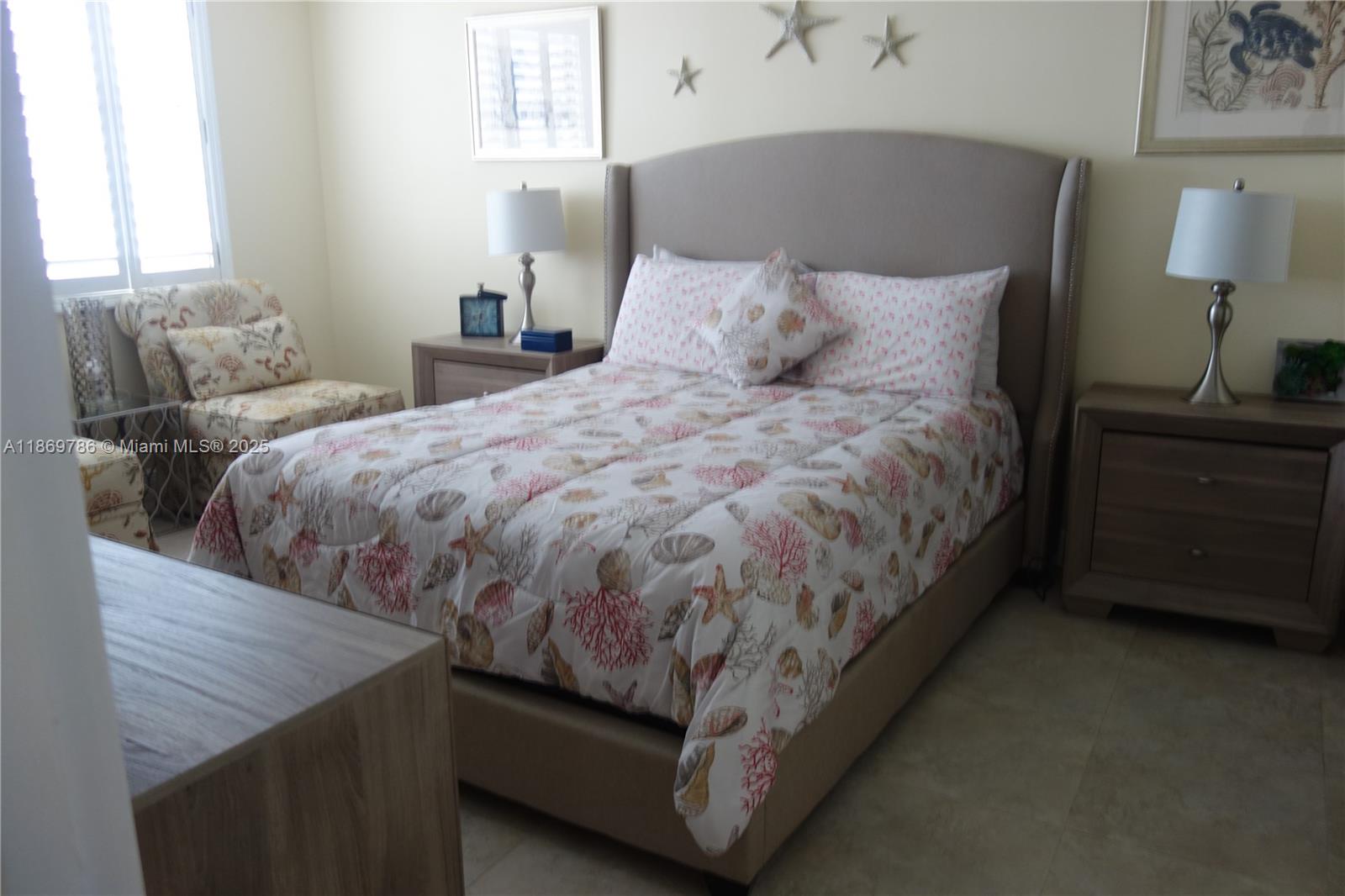 5701 Collins Avenue, Unit 1510 Miami Beach, FL 33140 - Photo 20 of 67 a bed sitting in a bedroom next to a lamp