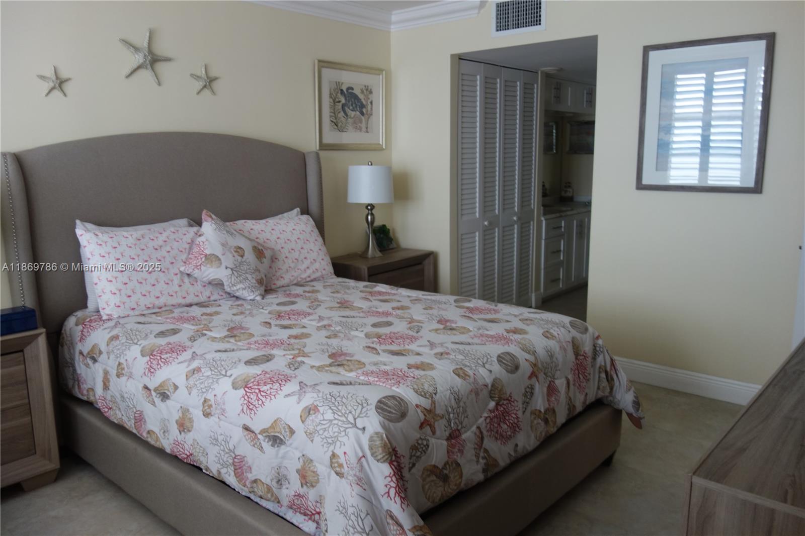 5701 Collins Avenue, Unit 1510 Miami Beach, FL 33140 - Photo 22 of 67 a large bed sitting in a bedroom next to a window