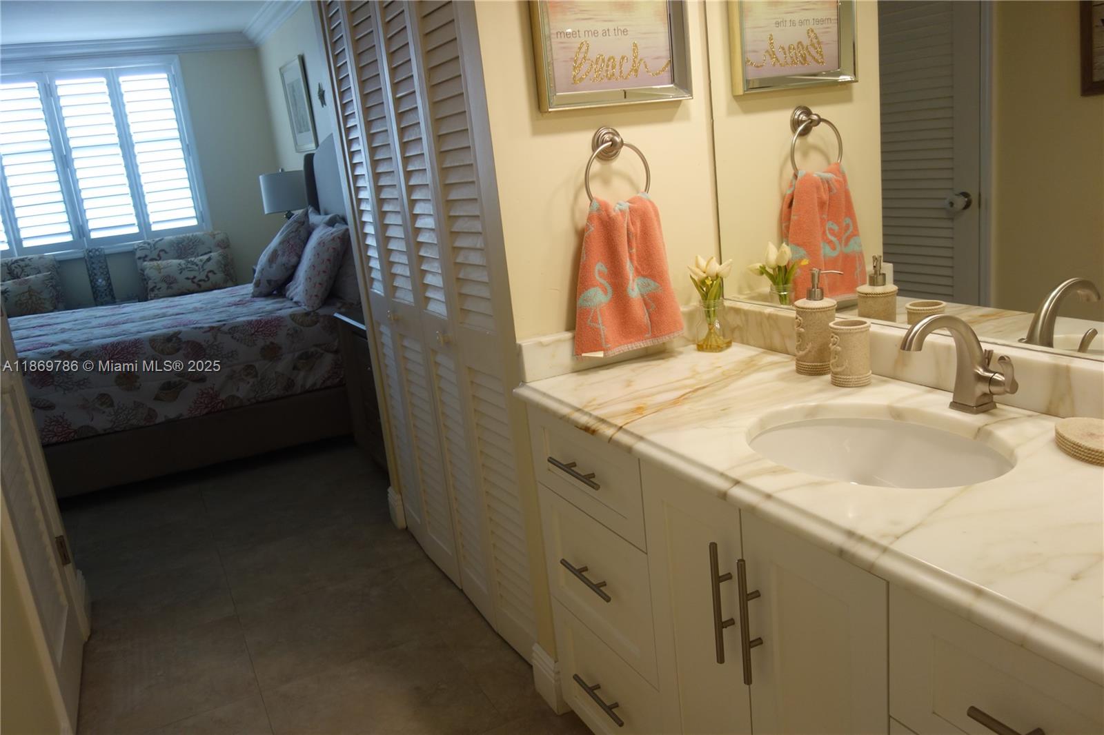 5701 Collins Avenue, Unit 1510 Miami Beach, FL 33140 - Photo 26 of 67 a bathroom with a sink and a mirror