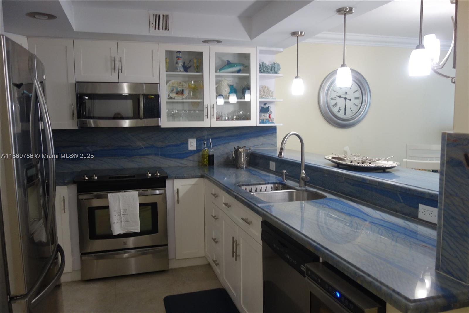 5701 Collins Avenue, Unit 1510 Miami Beach, FL 33140 - Photo 3 of 67 a kitchen with granite countertop stainless steel appliances a stove and a sink