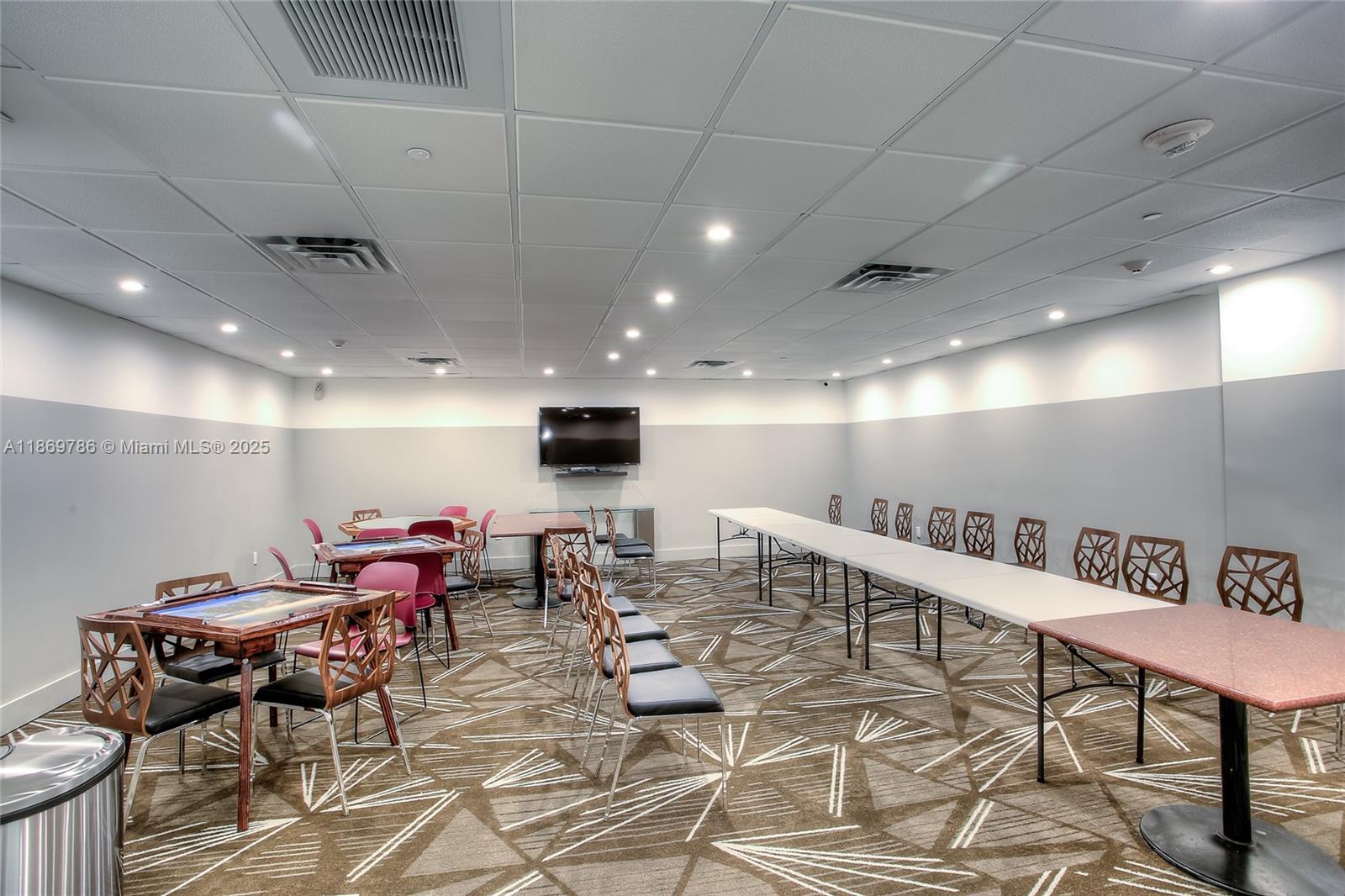 5701 Collins Avenue, Unit 1510 Miami Beach, FL 33140 - Photo 35 of 67 a living room with lots of furniture and a wooden floor