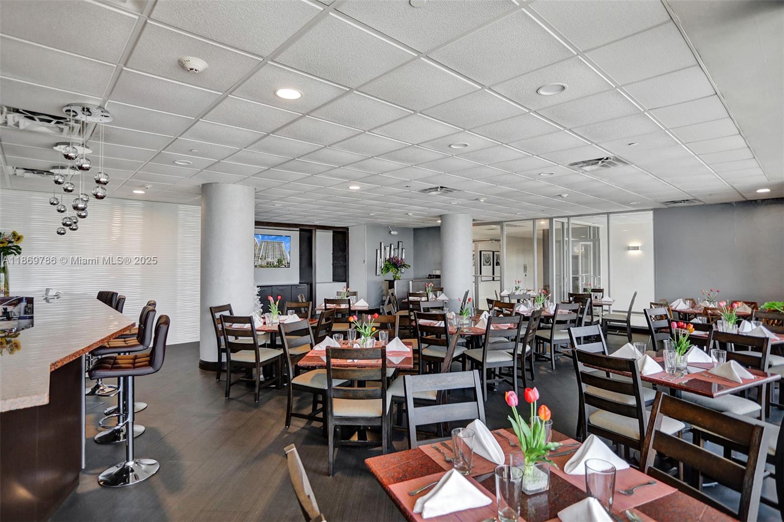 5701 Collins Avenue, Unit 1510 Miami Beach, FL 33140 - Photo 40 of 67 a room with lots of chairs a desk and a rug