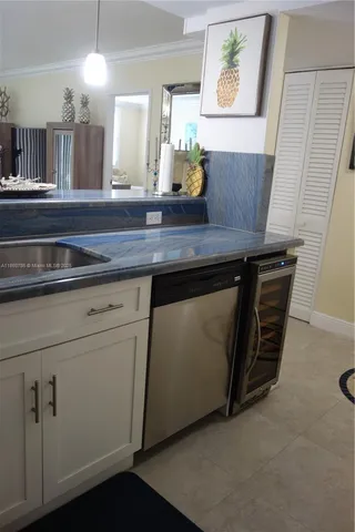 a view of a kitchen with appliances and wooden floor