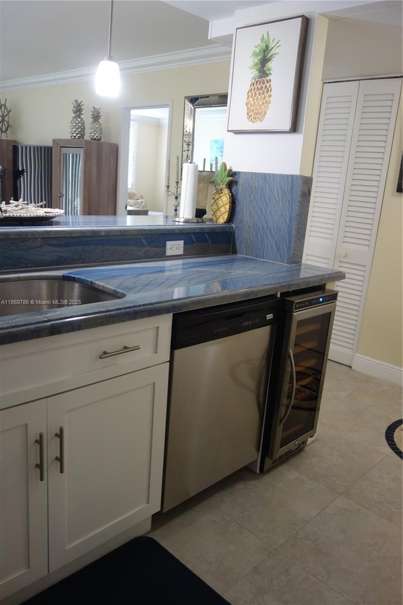 5701 Collins Avenue, Unit 1510 Miami Beach, FL 33140 - Photo 4 of 67 a view of a kitchen with appliances and wooden floor