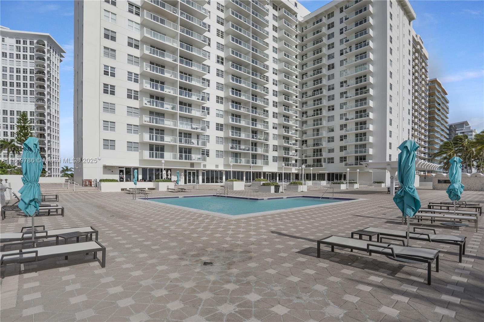 5701 Collins Avenue, Unit 1510 Miami Beach, FL 33140 - Photo 46 of 67 front view of a building with a street