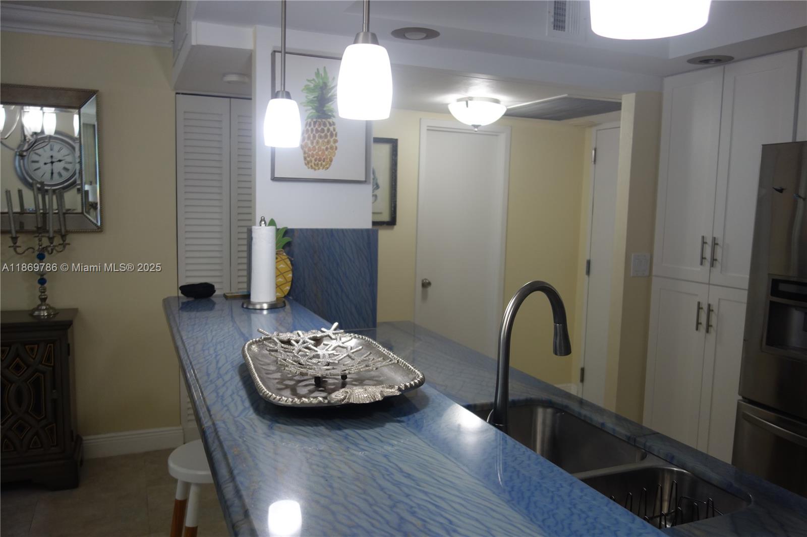 5701 Collins Avenue, Unit 1510 Miami Beach, FL 33140 - Photo 5 of 67 a view of a hallway with furniture and wooden floor