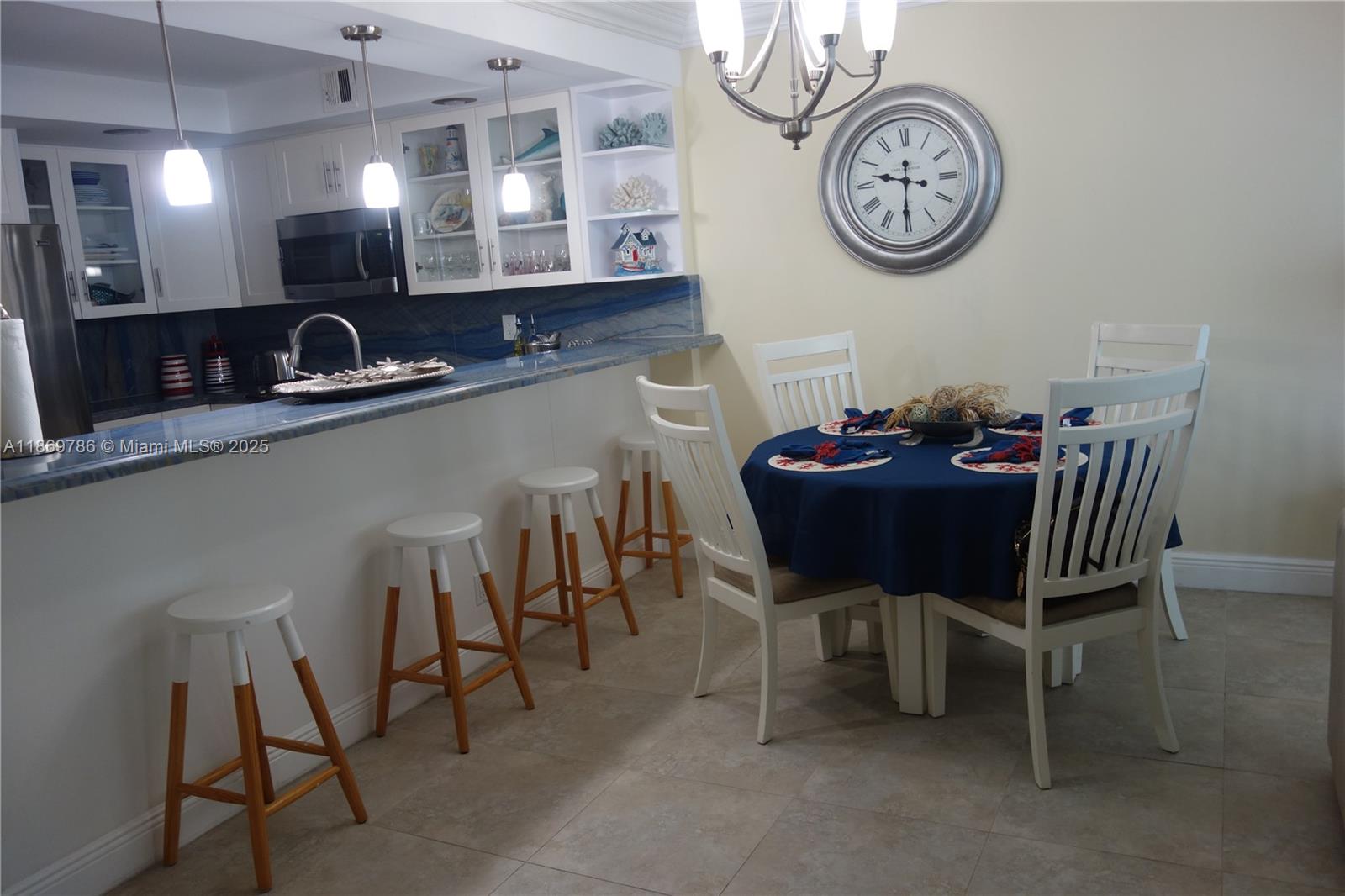 5701 Collins Avenue, Unit 1510 Miami Beach, FL 33140 - Photo 6 of 67 a view of a dining room with furniture and a chandelier