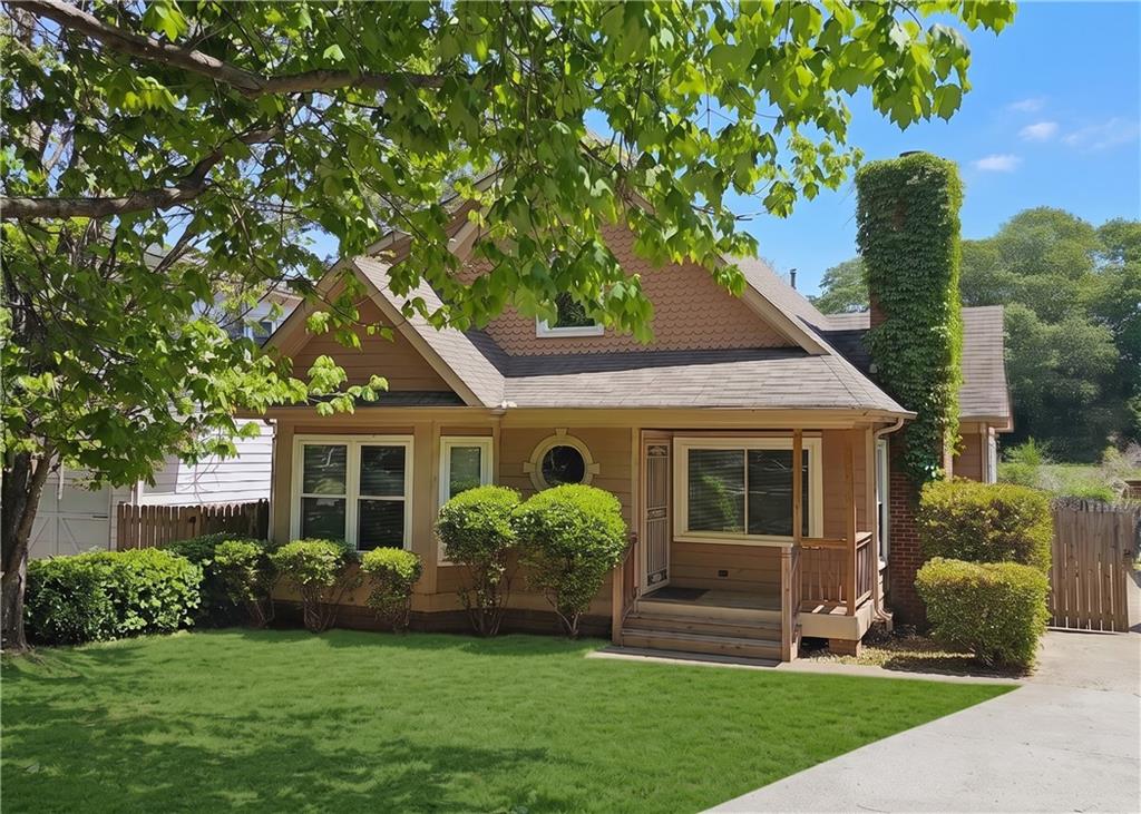 a front view of a house with a garden and yard