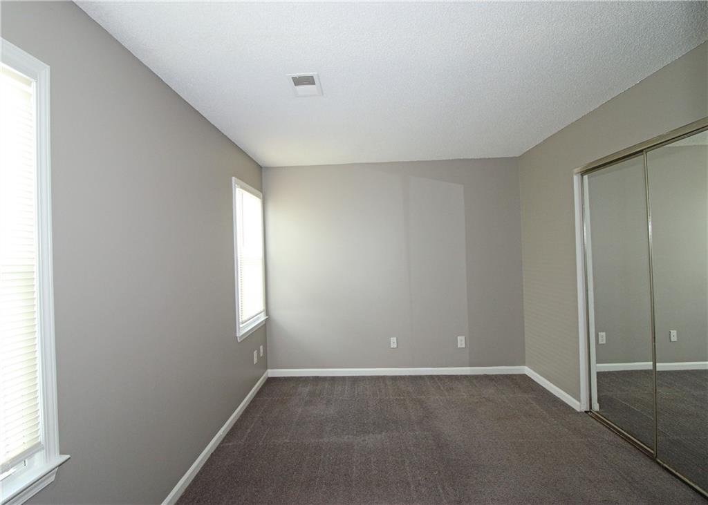 957 Oak Street Southwest Atlanta, GA 30310 - Photo 11 of 17 an empty room with windows and closet