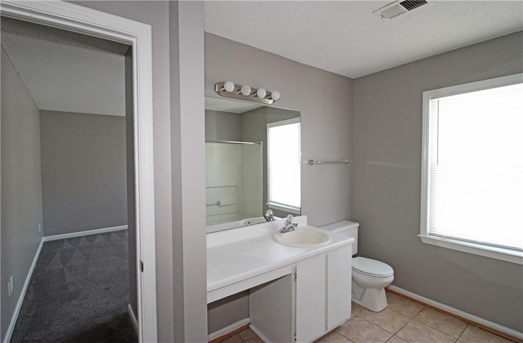957 Oak Street Southwest Atlanta, GA 30310 - Photo 13 of 17 a bathroom with a sink a toilet and mirror