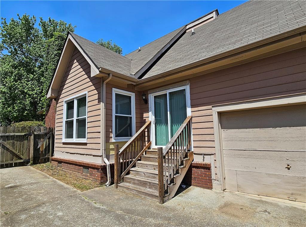 957 Oak Street Southwest Atlanta, GA 30310 - Photo 16 of 17 a view of a house with wooden fence and two windows