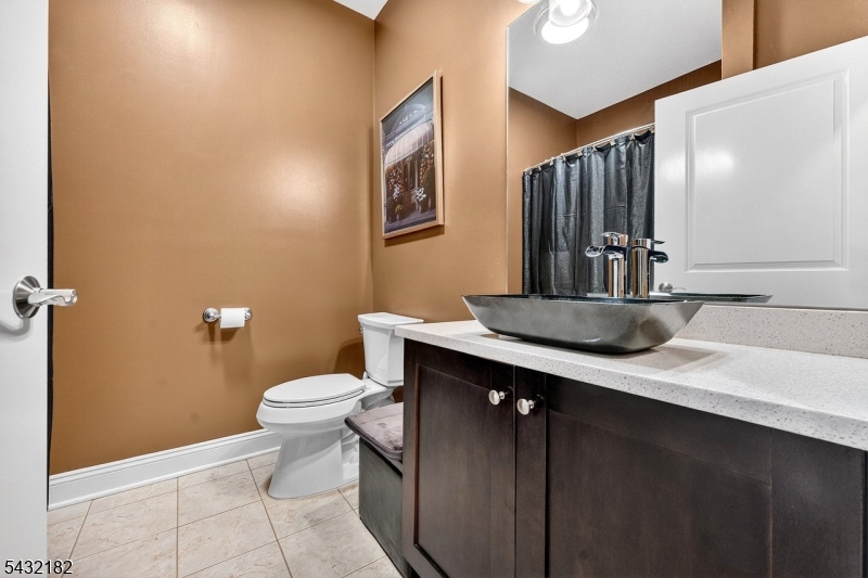 119 River Road Somerville, NJ 08876 - Photo 25 of 30 a bathroom with a sink a toilet a mirror and vanity