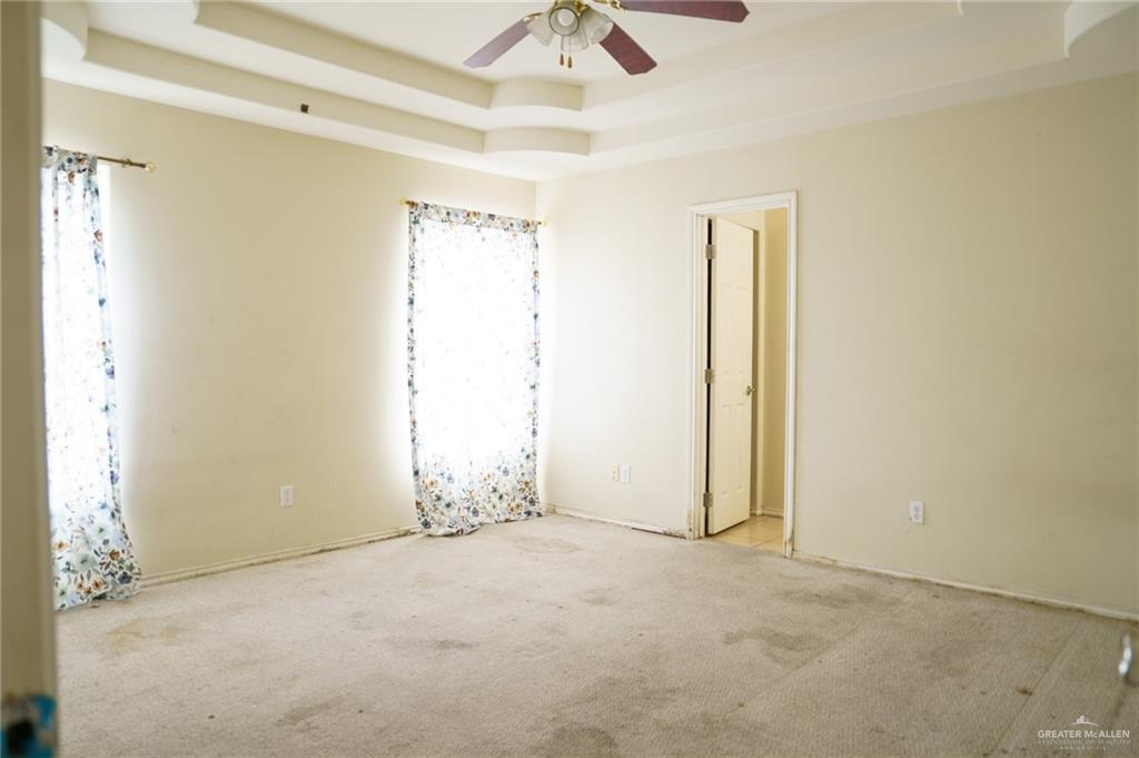 413 31st Street Hidalgo, TX 78557 - Photo 11 of 13 an empty room with chandelier fan