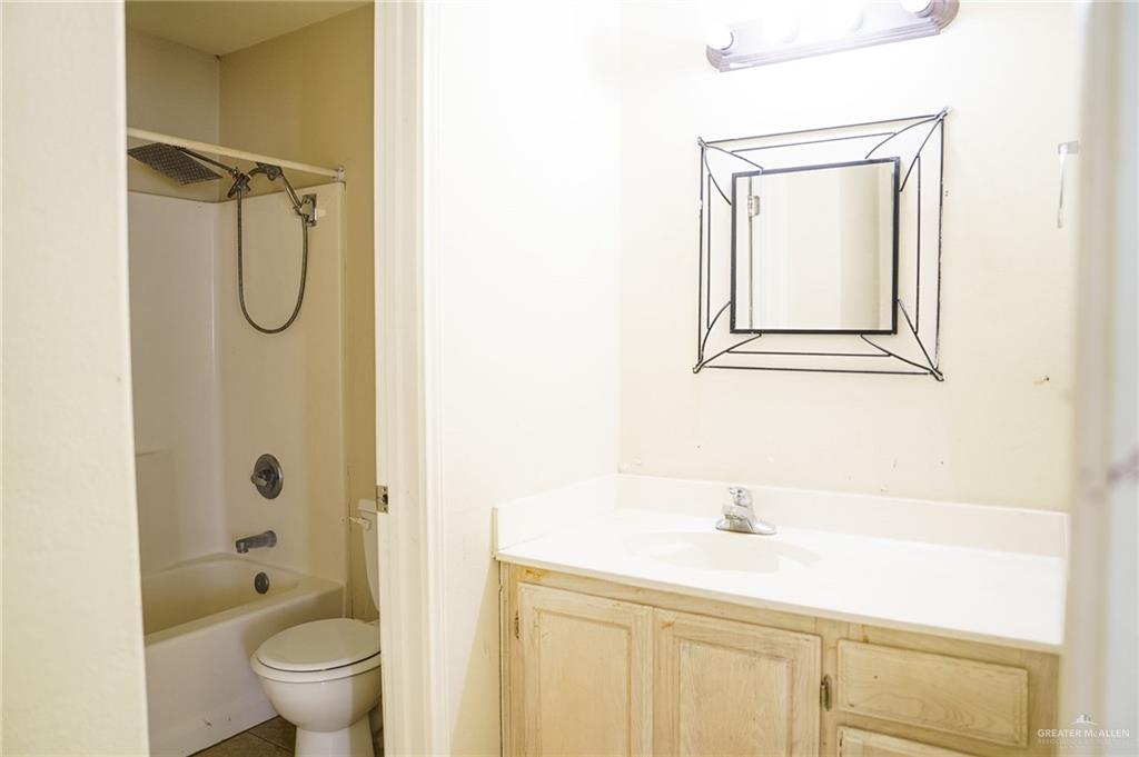 413 31st Street Hidalgo, TX 78557 - Photo 12 of 13 a bathroom with a shower a toilet and a sink