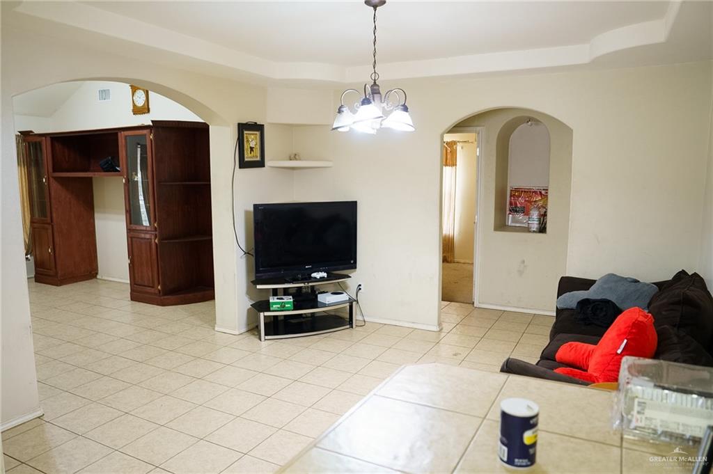 413 31st Street Hidalgo, TX 78557 - Photo 3 of 13 a living room with furniture and a flat screen tv