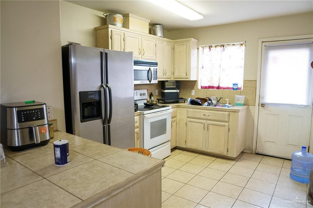 413 31st Street Hidalgo, TX 78557 - Photo 4 of 13 a kitchen with a sink appliances and cabinets