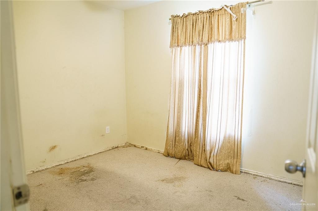 413 31st Street Hidalgo, TX 78557 - Photo 8 of 13 an empty room with windows