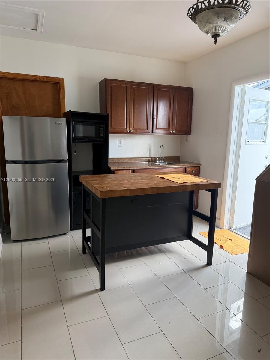 13410 Southwest 81st Street, Unit 2 Miami, FL 33183 - Photo 2 of 6 a room with cabinets and refrigerator