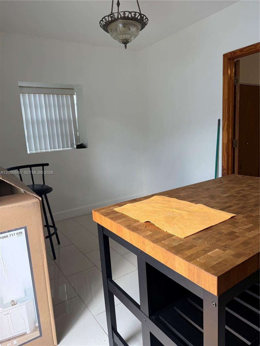13410 Southwest 81st Street, Unit 2 Miami, FL 33183 - Photo 4 of 6 a room with table and chair