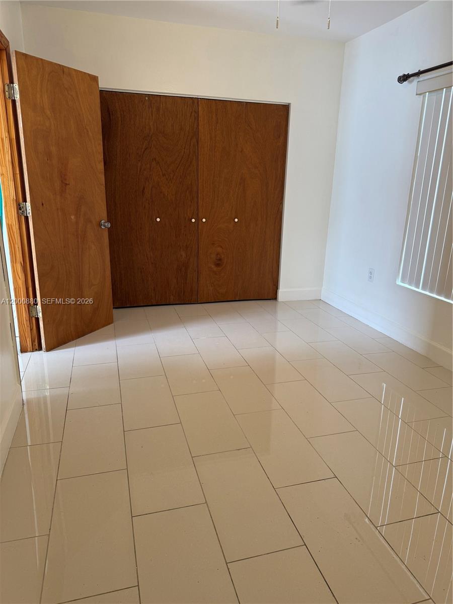 13410 Southwest 81st Street, Unit 2 Miami, FL 33183 - Photo 5 of 6 an empty room with windows