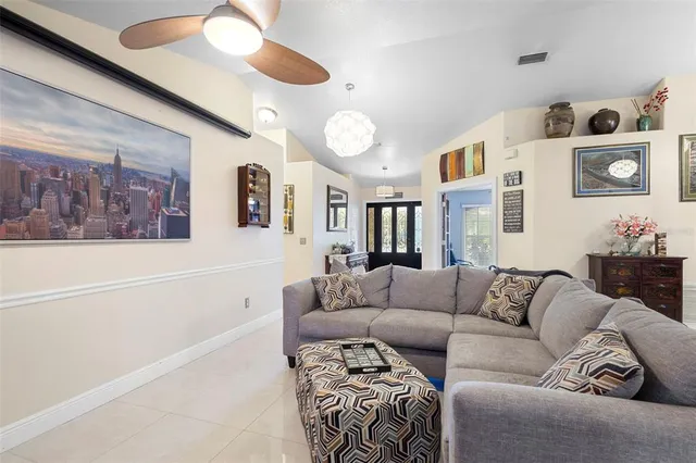 a living room with furniture a fireplace and a chandelier