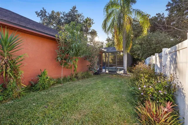 a front view of a house with a yard and a tree