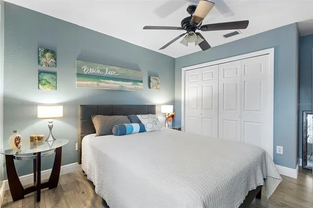 a bedroom with a bed and a flat tv screen on the dresser