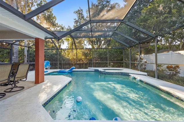 a view of a dining room with furniture wooden floor and chandelier