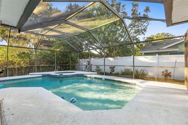 a view of a dining room with furniture wooden floor and a floor to ceiling window
