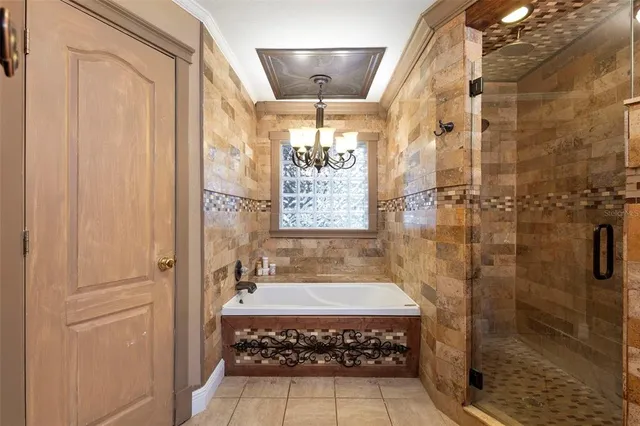 a bathroom with a glass shower door and a bathtub