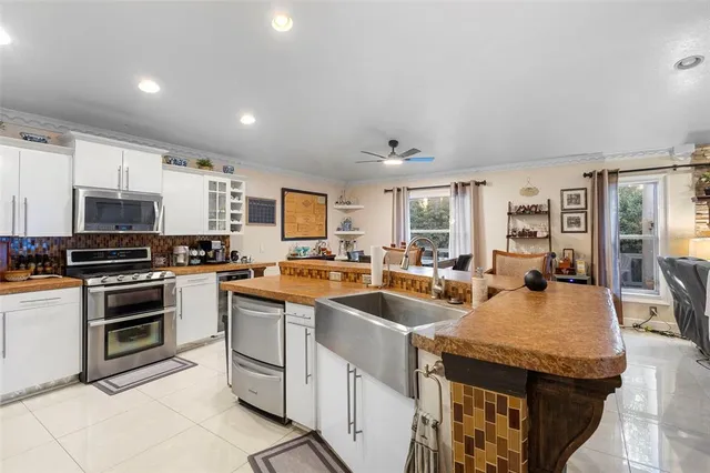 a kitchen with stainless steel appliances granite countertop a refrigerator and a sink