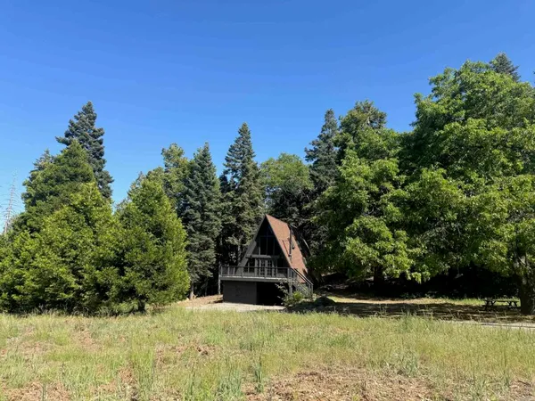 a view of a wooden house with a yard