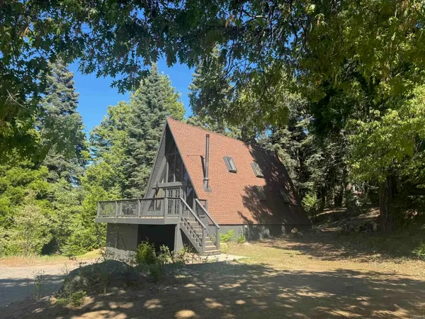 a view of backyard with wooden fence
