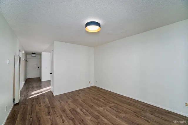 a view of a room that has a bed and a window