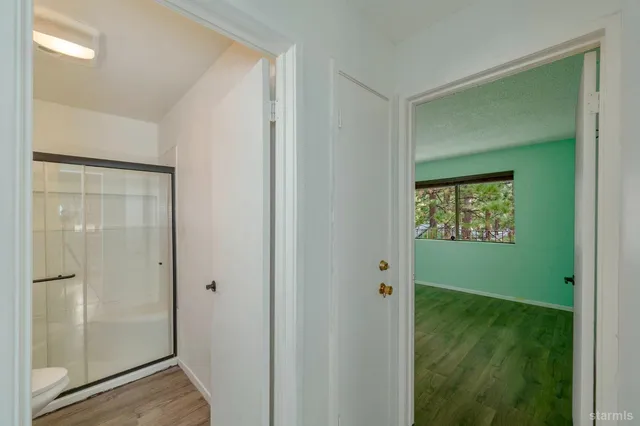 a room with wooden floor and closet