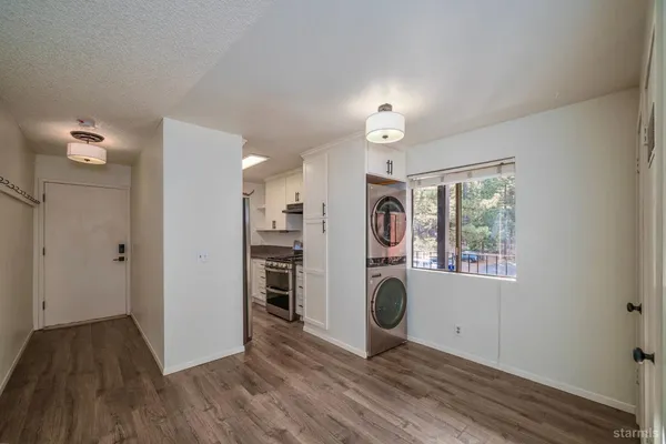 a view of a hallway with washer and dryer