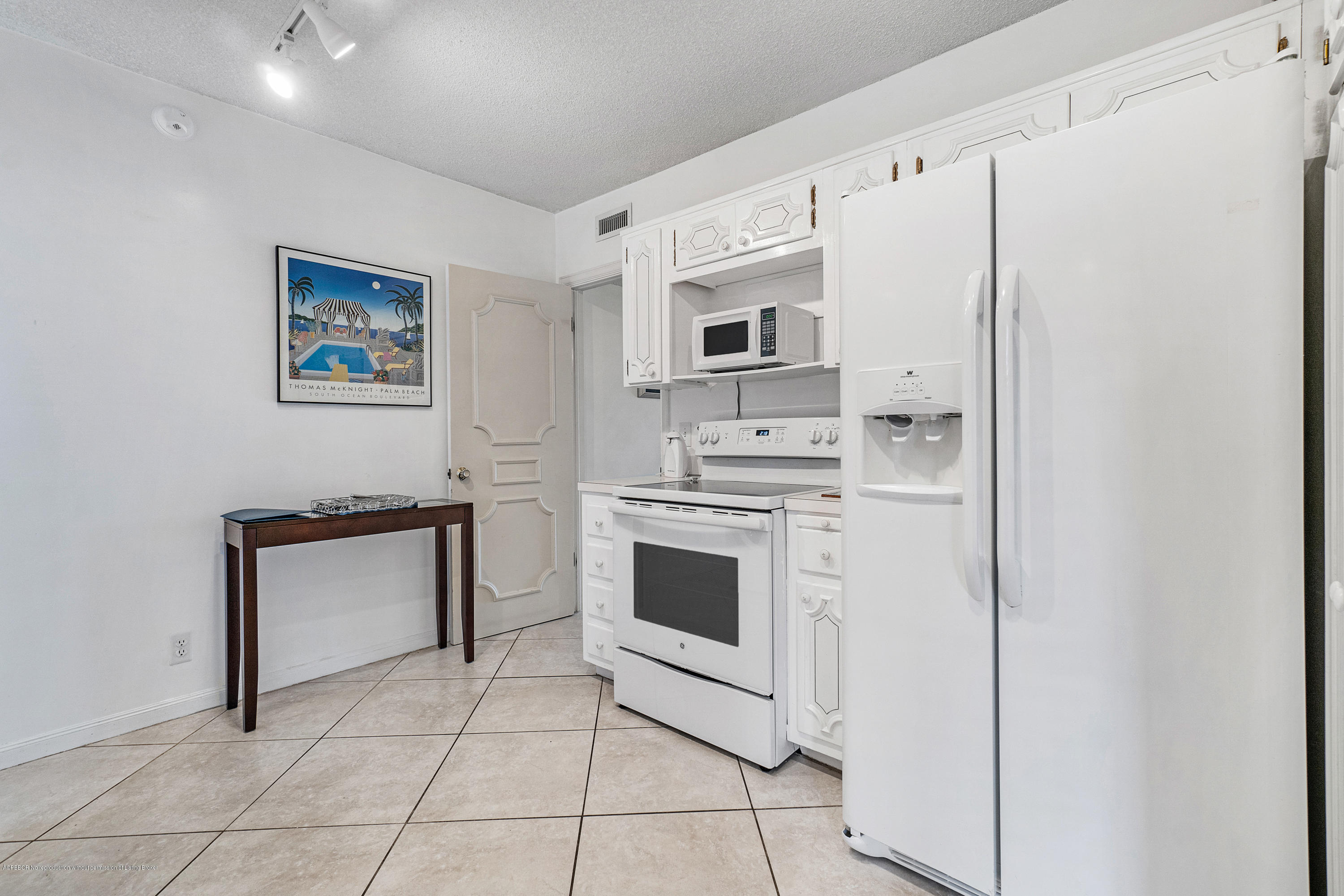 2185 Ibis Isle Road, Unit 40 Palm Beach, FL 33480 - Photo 14 of 28 a kitchen with stainless steel appliances a refrigerator sink and stove top oven