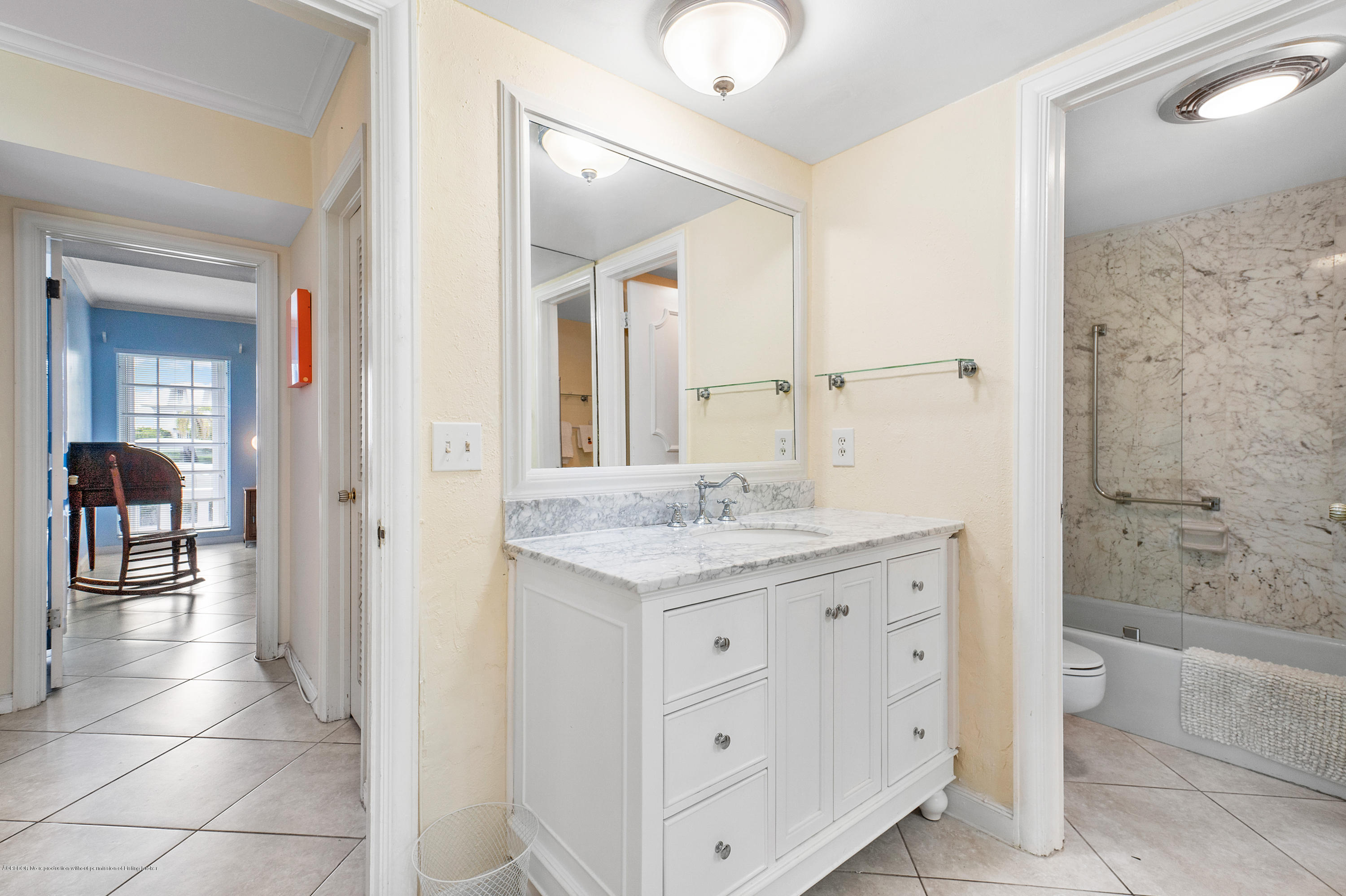 2185 Ibis Isle Road, Unit 40 Palm Beach, FL 33480 - Photo 18 of 28 a bathroom with a granite countertop sink a mirror and a bathtub