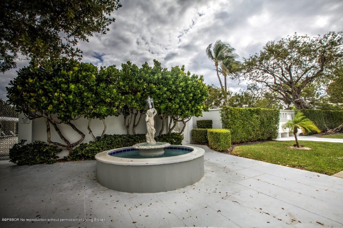 2185 Ibis Isle Road, Unit 40 Palm Beach, FL 33480 - Photo 26 of 28 a view of a water fountain and a fire pit in the background