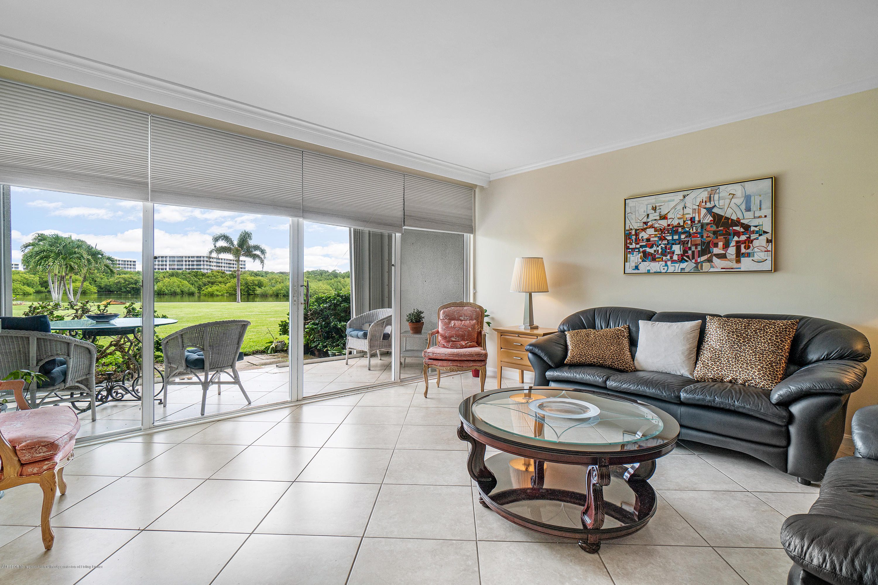 2185 Ibis Isle Road, Unit 40 Palm Beach, FL 33480 - Photo 5 of 28 a living room with furniture a dining table and a large window with garden view